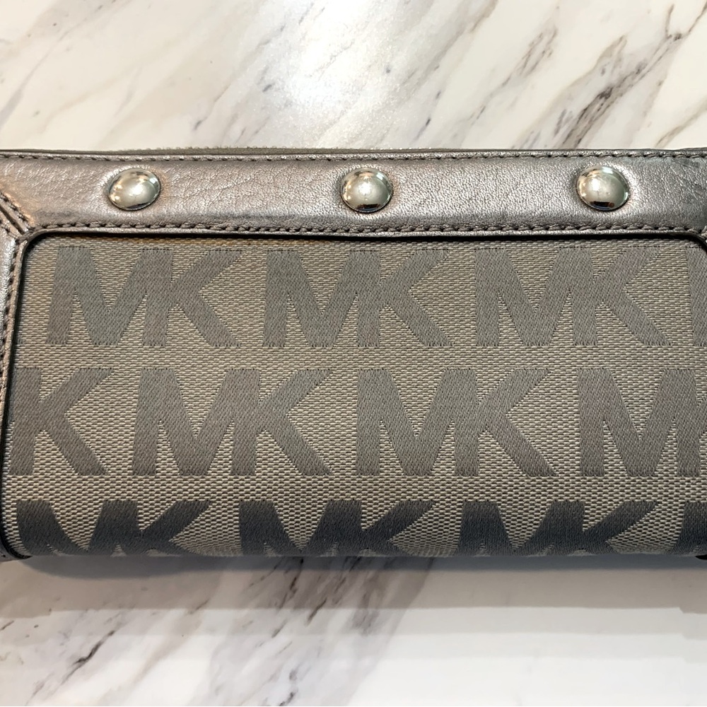 Michael Kors grey signature wallet with studded gunmetal leather trim.